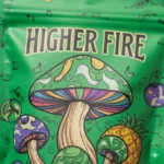 Detail of Higher Fire 4 gram mushroom gummy green apple packaging with psychedelic mushroom artwork