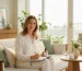 Confident Oakville woman in her 40s managing perimenopause naturally with cannabis oil and wellness journal in modern home