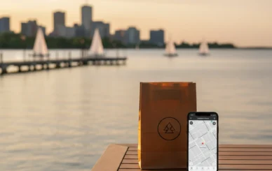 Burlington weed delivery package on lakefront porch with Spencer Smith Park waterfront at sunset, smartphone tracking map