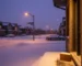 Milton cannabis delivery package on snowy doorstep during winter evening with warm home lighting and suburban street scene